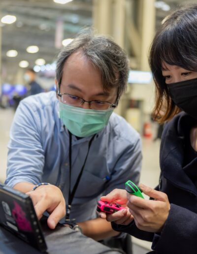 a man and a woman playing Nintendo Switch at G-EIGHT game show