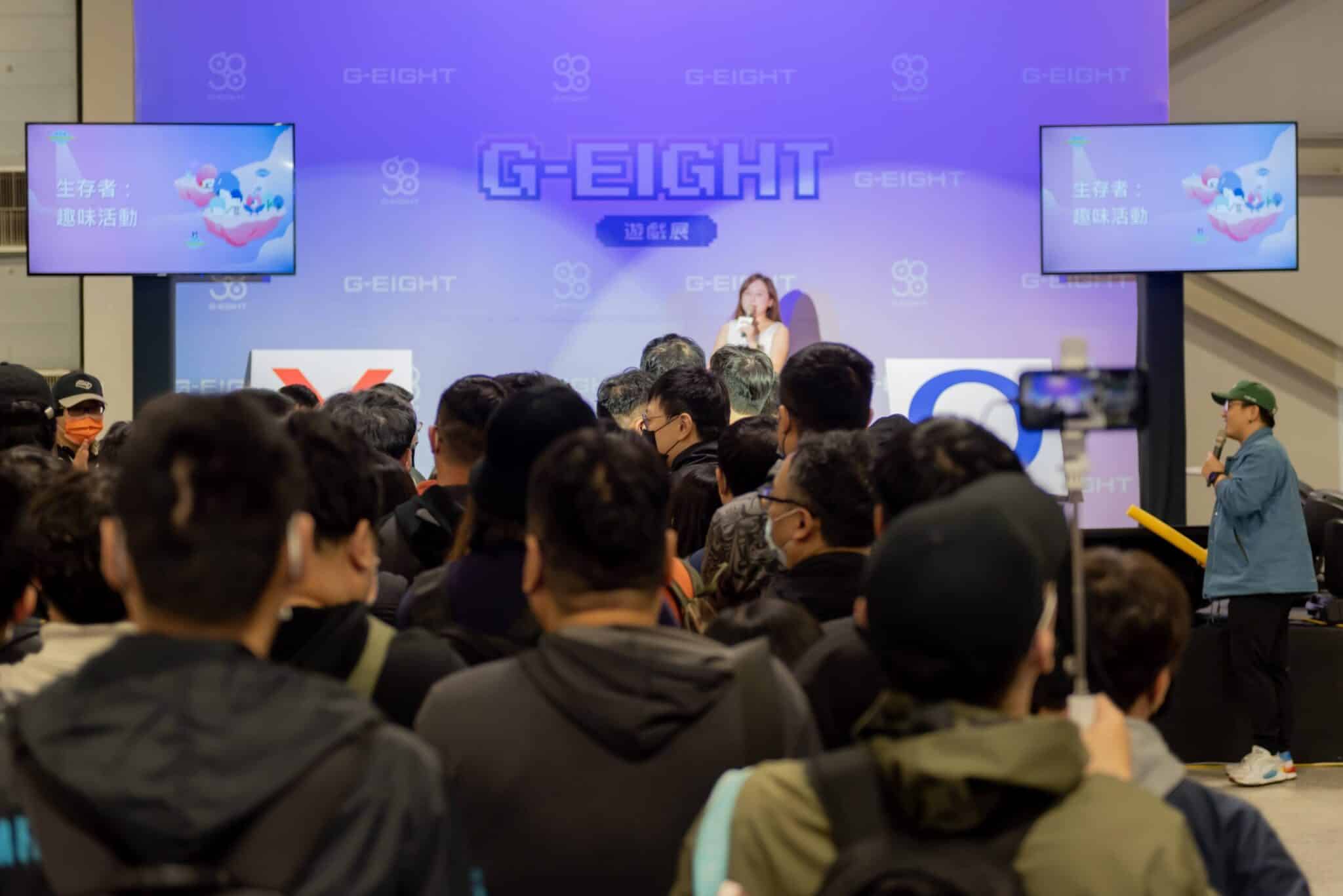 Group of people gather at G-EIGHT game show stage
