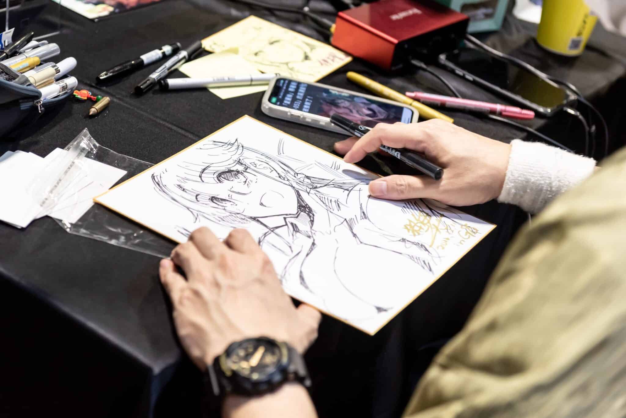 game illustrator doing live drawing at G-EIGHT game show